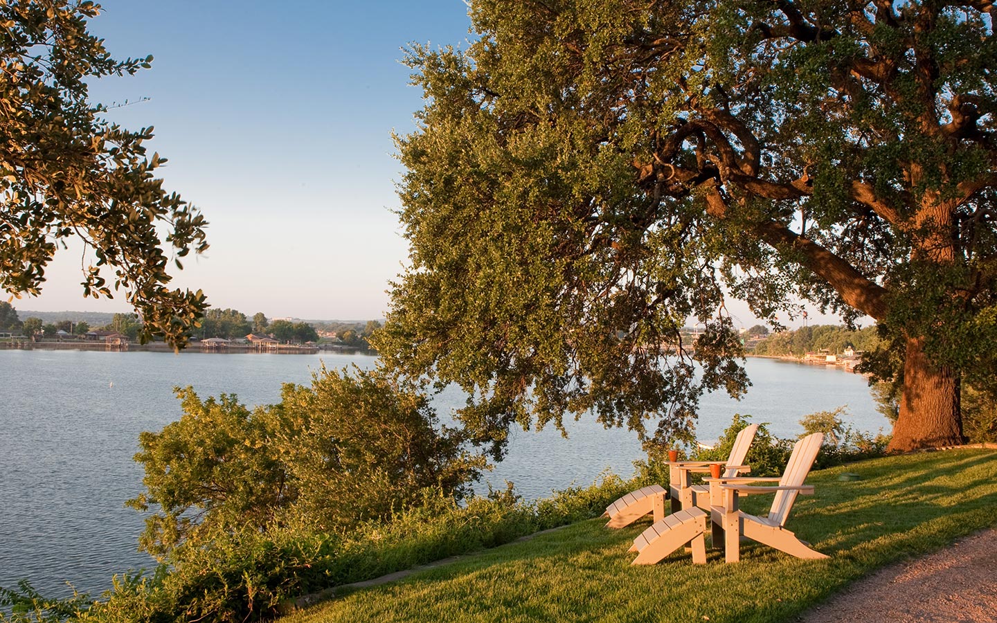 Two chairs at the edge of the lake at the Inn on Lake Granbury
