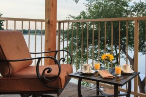 Coffee and orange juice on table outside on deck over water