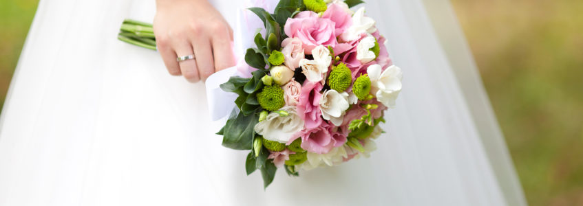 bride holding pink and green flowers