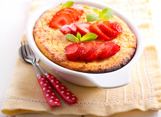 Ricotta cheese souffle in a tin with strawberry garnish