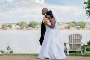 Bride and Father walking with lake background