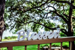 The word blessed sitting on railing outside