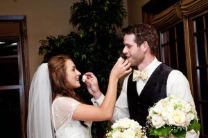 bride and groom feeding each other cake