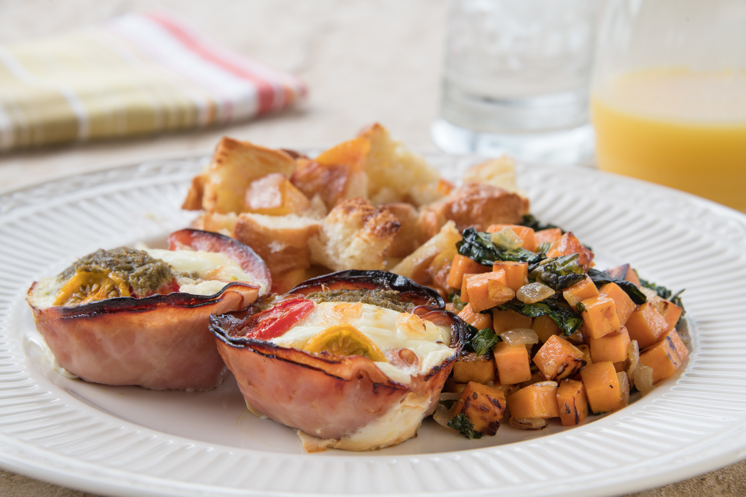 Fresh made egg cups and potatoes with juice and water